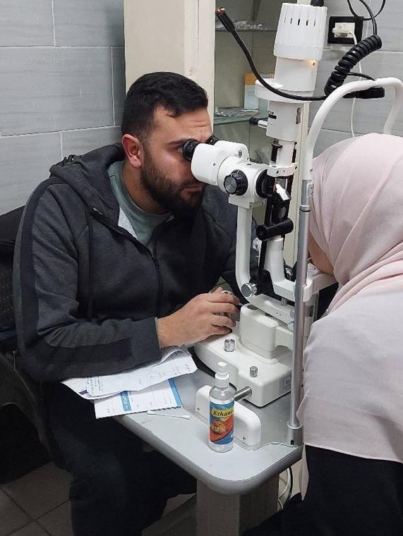 Ophthalmologist conducting a slit-lamp examination for a resident in El Amrawy